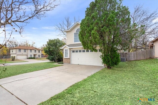 view of front of property with a garage, central air condition unit, and a front yard