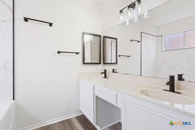 bathroom with hardwood / wood-style floors and vanity