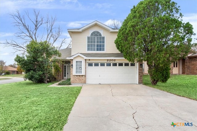 view of front of property featuring a garage and a front lawn