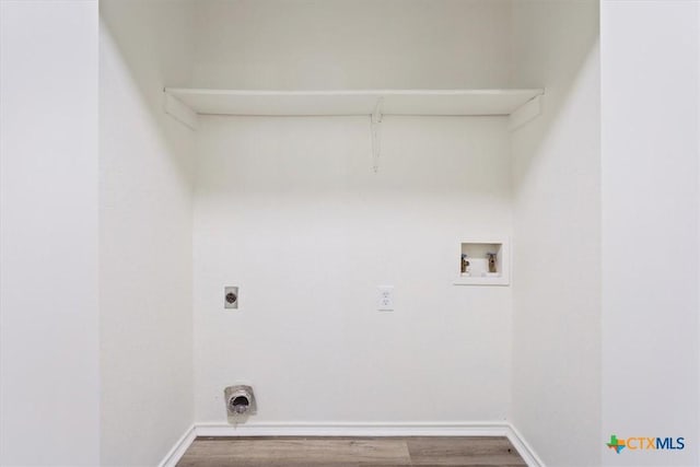 clothes washing area featuring hookup for a washing machine, hardwood / wood-style flooring, and electric dryer hookup