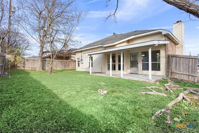 rear view of property with french doors, a yard, and a patio area