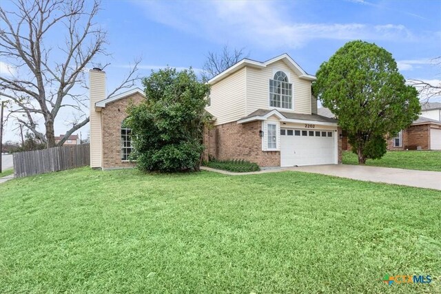 view of property with a front yard and a garage