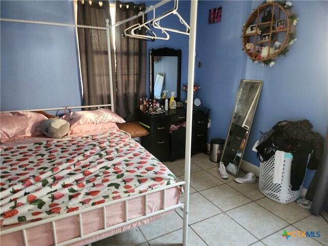 tiled bedroom with a closet