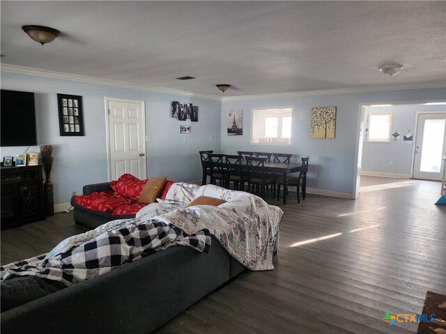 living room featuring dark hardwood / wood-style flooring and ornamental molding