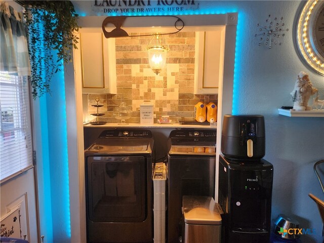 kitchen with decorative backsplash and separate washer and dryer