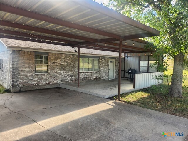 view of patio featuring area for grilling and a carport