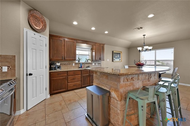 6704 Deorsam Loop, Killeen, TX 76542 - kitchen with stainless steel range oven, healthy amount of natural light, a kitchen bar, a center island, and recessed lighting
