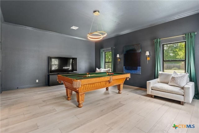 playroom featuring a wealth of natural light, ornamental molding, light wood-type flooring, and billiards