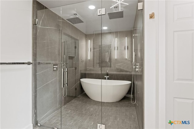 bathroom featuring tile patterned floors and separate shower and tub