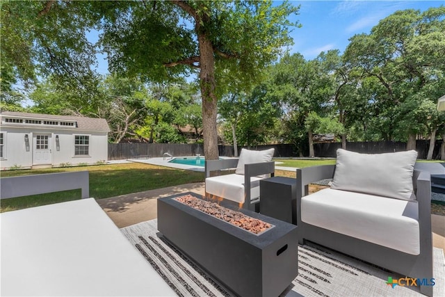 view of patio / terrace with a fenced in pool and an outdoor living space with a fire pit