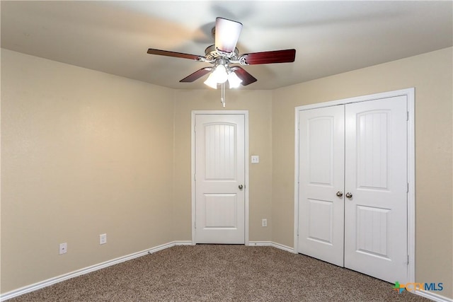 unfurnished bedroom featuring ceiling fan, a closet, and carpet floors