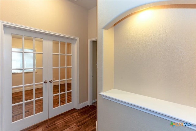 hall featuring dark hardwood / wood-style flooring and french doors