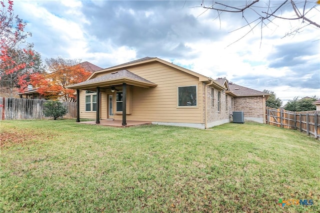 back of house with a lawn, central AC, and a patio