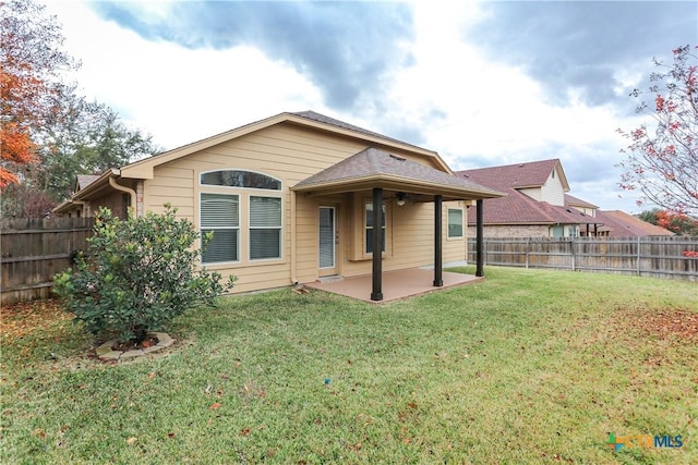 back of property featuring a yard and a patio area