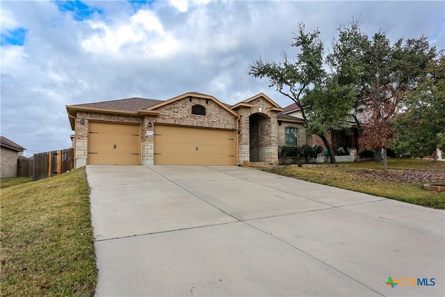 view of front of house with a garage and a front lawn