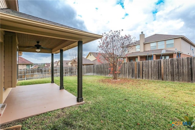 view of yard featuring a patio area and ceiling fan