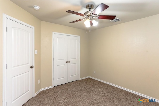 unfurnished bedroom featuring carpet flooring, ceiling fan, and a closet