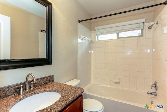 full bathroom featuring toilet, vanity, and tiled shower / bath