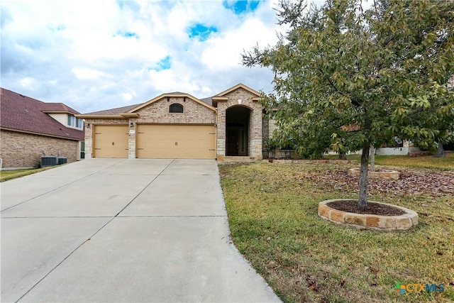 view of front facade with a garage and a front lawn