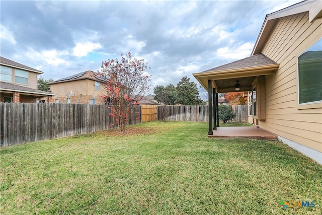 view of yard with ceiling fan and a patio area