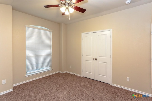 unfurnished bedroom with carpet floors, a closet, and ceiling fan