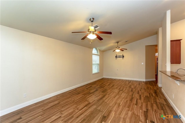 spare room with hardwood / wood-style floors, ceiling fan, and lofted ceiling