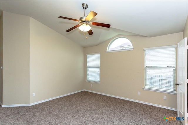 carpeted spare room with ceiling fan and lofted ceiling