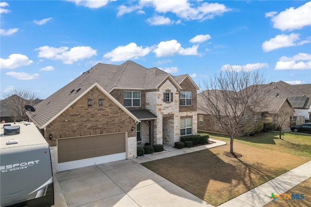 view of front of home with a garage and a front yard