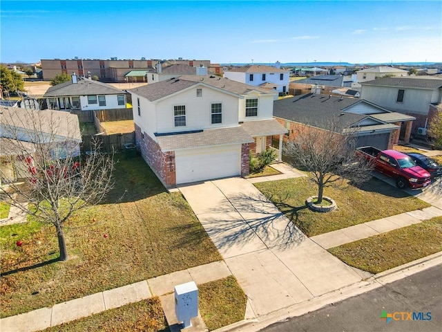 view of front of property featuring a garage and a front yard