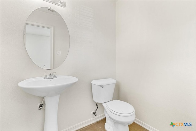 bathroom with tile patterned floors, sink, and toilet