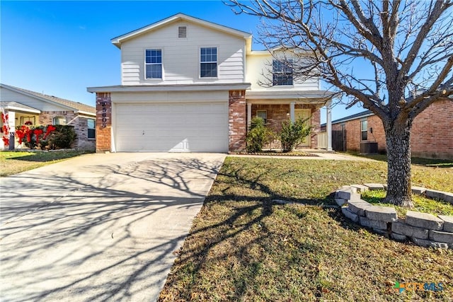 view of front property featuring a garage, a front yard, and central AC