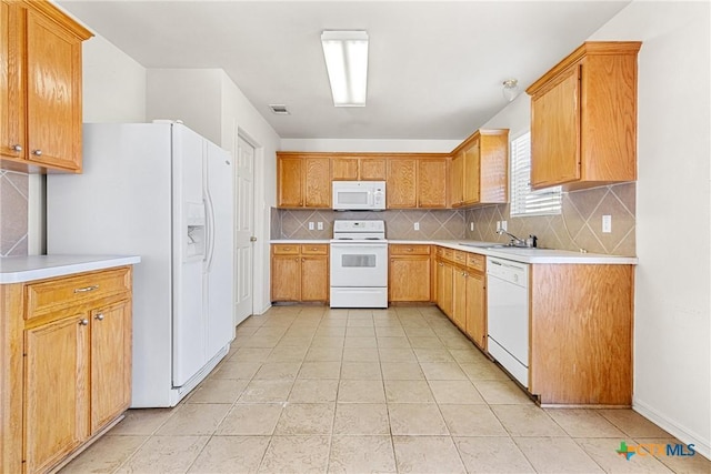 kitchen featuring decorative backsplash, white appliances, sink, and light tile patterned floors