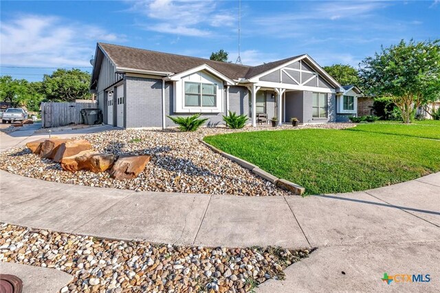 1407 Plantation Rd, Victoria, TX 77904 - ranch-style home featuring a garage, a front lawn, brick siding, and concrete driveway