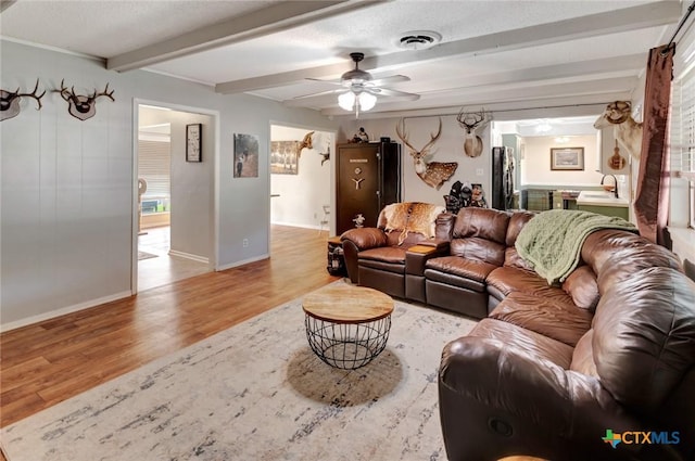 1407 Plantation Rd, Victoria, TX 77904 - living area featuring wood finished floors, beamed ceiling, ceiling fan, and baseboards