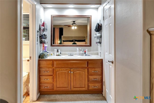 1407 Plantation Rd, Victoria, TX 77904 - bathroom with vanity, ceiling fan, and toilet