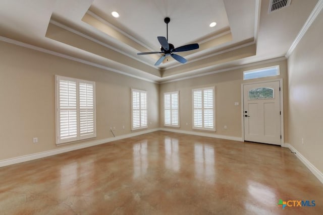 interior space featuring a tray ceiling, visible vents, baseboards, and concrete floors