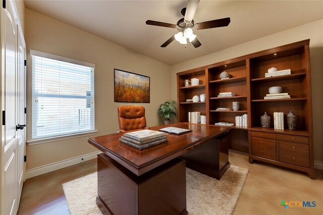 home office with baseboards and a ceiling fan