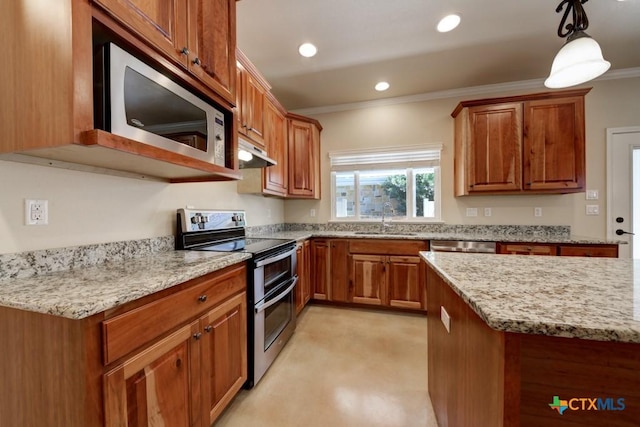 kitchen with crown molding, under cabinet range hood, brown cabinetry, stainless steel appliances, and a sink