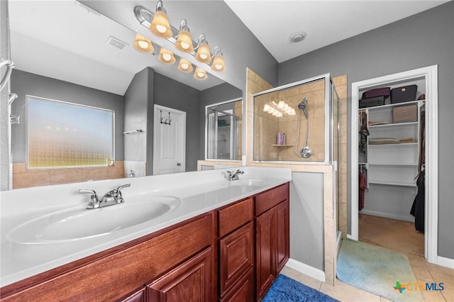 211 W Vega Ln, Killeen, TX 76542 - bathroom with a stall shower, double vanity, a walk in closet, and tile patterned flooring
