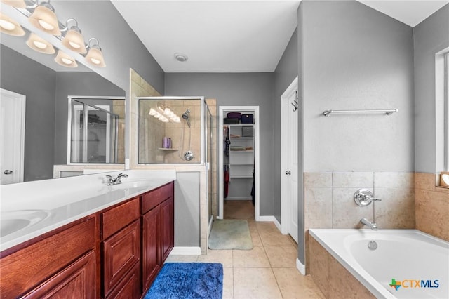 211 W Vega Ln, Killeen, TX 76542 - full bath with a garden tub, a shower stall, double vanity, a spacious closet, and tile patterned flooring