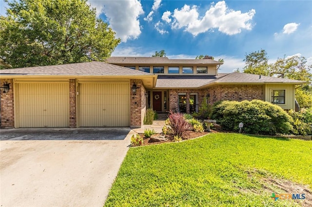 view of front of property with a garage and a front lawn