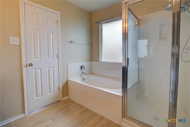 525 Tom Kemp Dr, New Braunfels, TX 78130 - full bath with wood finished floors, a garden tub, and a stall shower