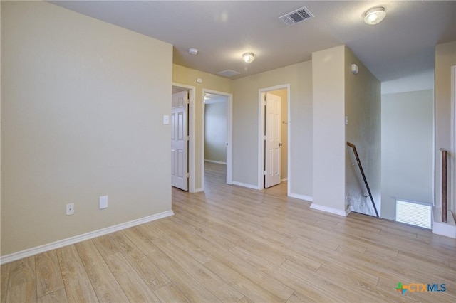 empty room with light hardwood / wood-style floors