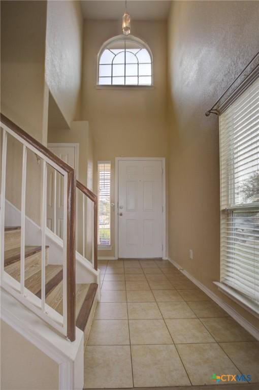 525 Tom Kemp Dr, New Braunfels, TX 78130 - foyer entrance featuring stairway, a high ceiling, and light tile patterned floors