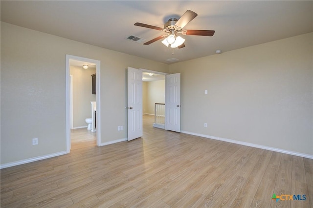 unfurnished bedroom with connected bathroom, light hardwood / wood-style floors, and ceiling fan