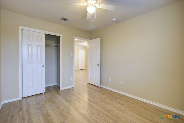 unfurnished bedroom with a closet, light hardwood / wood-style flooring, and ceiling fan