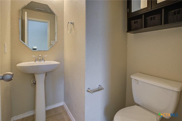 525 Tom Kemp Dr, New Braunfels, TX 78130 - half bath featuring toilet and tile patterned floors