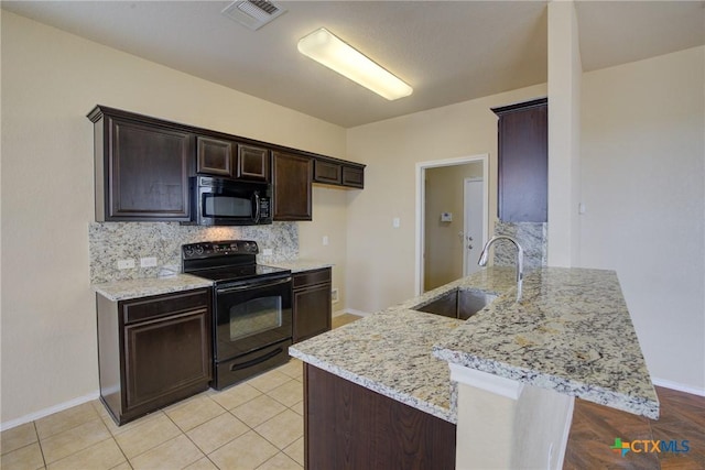 525 Tom Kemp Dr, New Braunfels, TX 78130 - kitchen featuring a sink, visible vents, dark brown cabinetry, decorative backsplash, and black appliances