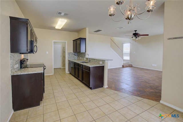525 Tom Kemp Dr, New Braunfels, TX 78130 - kitchen featuring visible vents, a sink, light tile patterned flooring, decorative backsplash, and black appliances