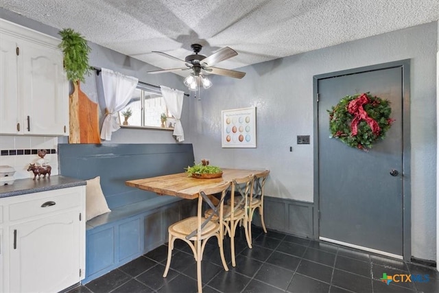 dining room with breakfast area, ceiling fan, and a textured ceiling